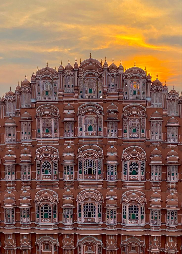 Hawa Mahal in Jaipur, showcasing its iconic pink sandstone façade with intricate lattice windows and historic Rajput architecture