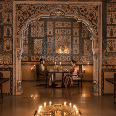 Elegant dining experience at Jamavar, The Leela Palace, featuring royal interiors, warm lighting, and a curated Indian fine-dining setup