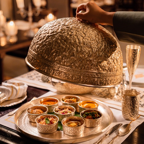 Elegant dining experience at Jamavar, The Leela Palace, featuring royal interiors, warm lighting, and a curated Indian fine-dining setup