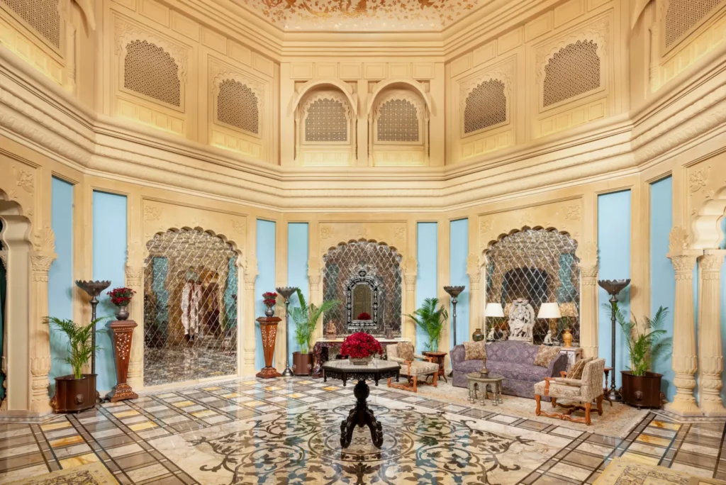 Opulent interiors of Raffles Jaipur showcasing grand staircases, intricate detailing, and royal palace aesthetics.